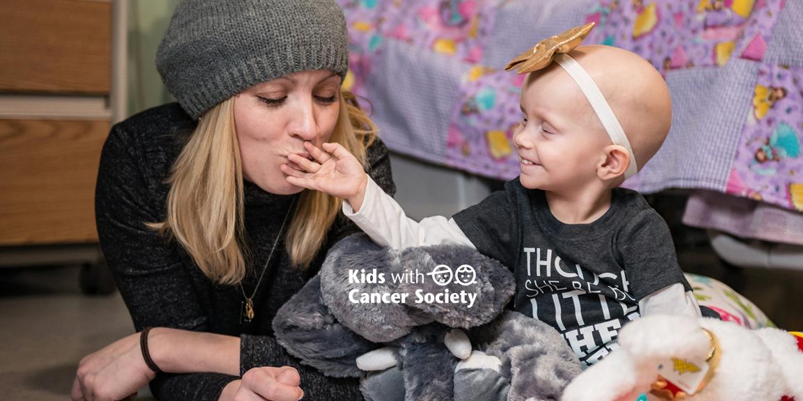 A child with cancer sharing a moment with her caregiver